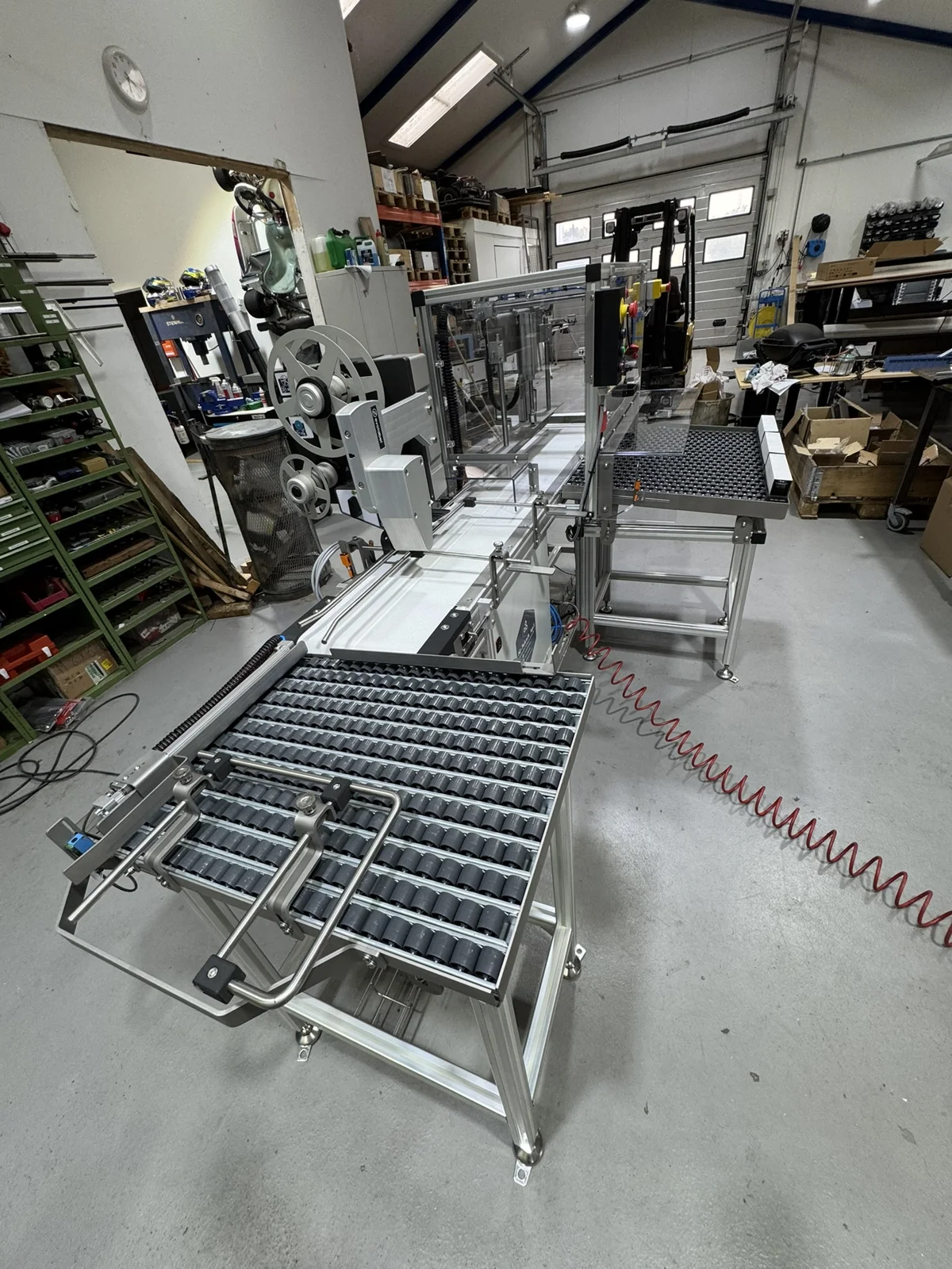 Maskinbyg med etikettering, transportbaner og afskærmning på JG Tekniks værksted